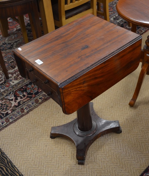 A Victorian mahogany drop-leaf side table with two drawers and opposing dummy drawers on a turned