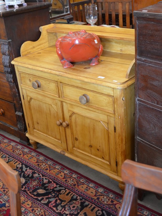 A small Victorian pine sideboard with galleried back, two drawers and panelled cupboard doors raised