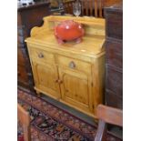 A small Victorian pine sideboard with galleried back, two drawers and panelled cupboard doors raised