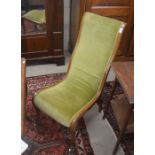 An Edwardian mahogany framed high-backed nursing chair with light green dralon upholstery