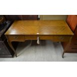 A French walnut and brass mounted writing table with three drawers