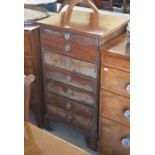 A small 19th century mahogany chest of seven graduating drawers with octagonal brass handles, raised