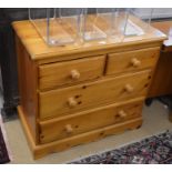 A modern pine chest of two short over two long drawers with turned handles