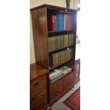 A Laura Ashley hardwood open bookcase with three shelves over four drawers with brass handles,