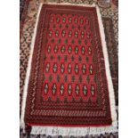A Persian Turkoman rug with seven rows of alternating motif on red ground, repeating borders 132 x