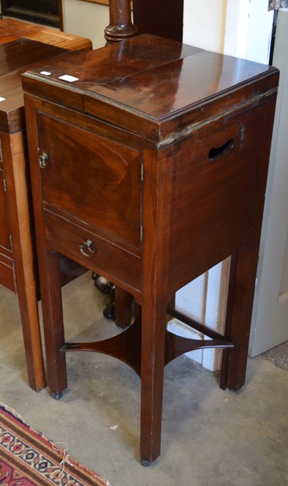 A Victorian mahogany wash stand/commode with twin hinged top, cupboard and single drawer raised on