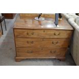 A 19th century mahogany chest of three long graduating drawers with brass handles, raised on