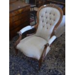 A Victorian carved mahogany salon arm chair with button backed natural linen upholstery