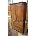 A 19th century mahogany wardrobe (converted from a linen press) with panelled doors over three