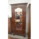 Maple & Co, London - A good quality Edwardian mahogany single wardrobe with blind fret-cut