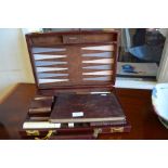 An Asprey, London brown leather and brass backgammon set, to/w an album of vintage Player's