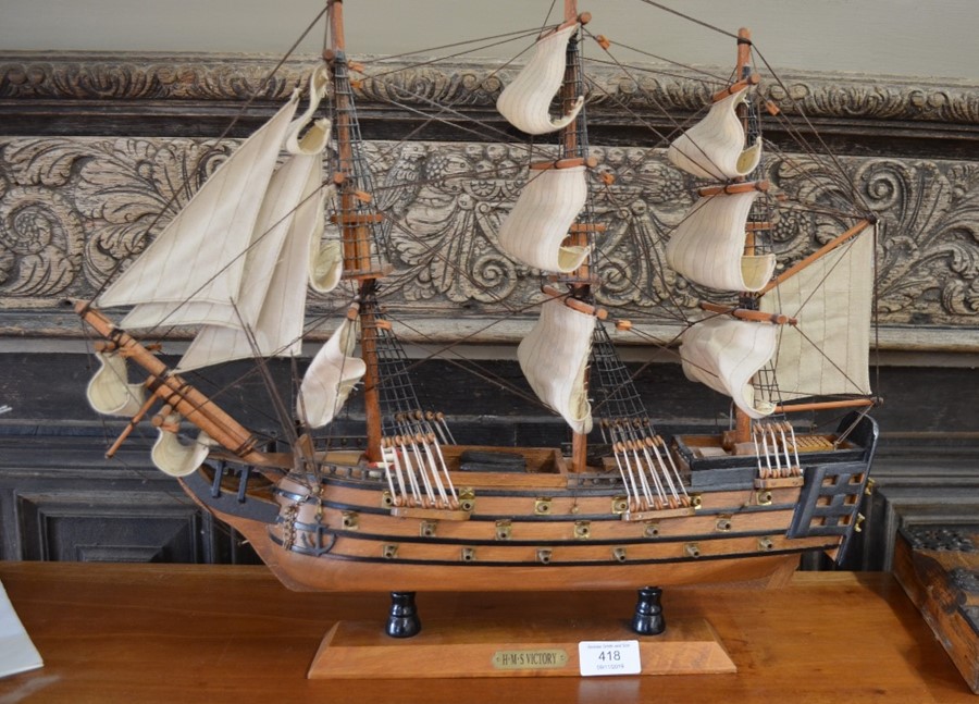 A wooden model of The HMS Victory under full sail