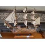 A wooden model of The HMS Victory under full sail
