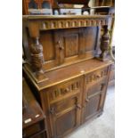 An Old Charm style carved oak court cupboard