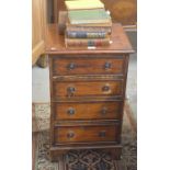 A small crossbanded mahogany chest of four drawers, raised on bracket feet