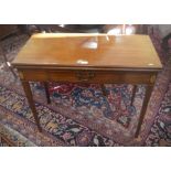 A Georgian mahogany inlaid tea table with folding top and frieze drawer raised on tapering square