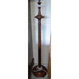 A mahogany turned and fluted standard lamp on circular platform base with bun feet