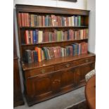 An 18th century style oak dresser, the plate rack with two open shelves over a base with three