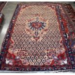 A Persian Kordi rug, central navy and red floral medallion on cream ground with diamond linked
