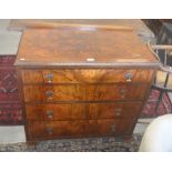 A walnut chest or four long graduating drawers, raised on shaped bracket feet