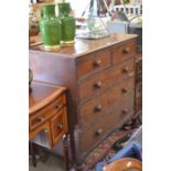 A Victorian mahogany chest of two short over three long drawers with turned handles and short turned