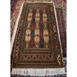 An unusual Turkoman cream ground rug 125 x 60 cm