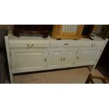 A French gloss white and brass mounted sideboard with three drawers and panelled cupboard doors to/w