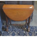 A Victorian mahogany sutherland table with turned gate leg action supports