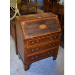 An Edwardian inlaid mahogany Sheraton style fall front bureau with fitted interior over three