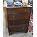 An early 20th century oak tall boy chest of four drawers