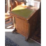 A yew wood davenport with tooled green leather top and four side drawers with brass campaign style