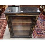 A 19th century ebonised, satin strung and gilt mounted pier cabinet with single glazed door