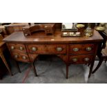 A Victorian bow-fronted mahogany sideboard raised on tapering square supports (A/F)