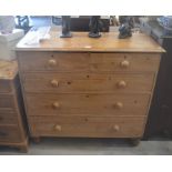 An antique pine chest of two short over three long drawers with turned handles and bun feet
