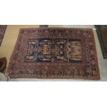 An antique worn Persian Shiraz rug 136 x 100 cm to/w a Baluchi navy ground prayer rug 139 x 95 cm