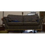 A country house three seater sofa with blue and gold damask style upholstery