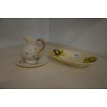 A Clarice Cliff Newport Pottery moulded oval dish, Belleek cream jug and saucer (3)