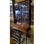 A glazed mahogany bookcase with two doors to/w an associated two drawer side table on pad footed