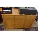 A John Lewis Ellis range light oak sideboard with three drawers and three panelled cupboards with