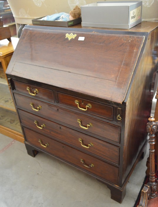 A Georgian mahogany fall front bureau with fitted interior, two short and three long drawers