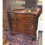 A Georgian style mahogany serpentine front chest with fluted canted corners and four drawers