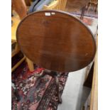 A 19th century mahogany occasional table, the circular tilt-top raised on a turned column and