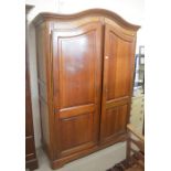 A large French mahogany dome top armoir with arched panelled doors