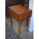 A Victorian mahogany drop-leaf side table with two drawers and opposing dummy drawers, raised on