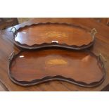 Two Victorian inlaid mahogany kidney-shaped galleried trays with brass handles (2)