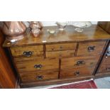 A Laura Ashley hardwood chest with an arrangement of eight drawers with large brass handles,