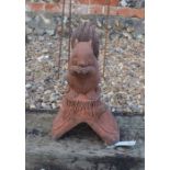 A composite cast terracotta squirrel mounted ridge tile