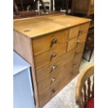 A Victorian stripped pine chest of four short over three long drawers