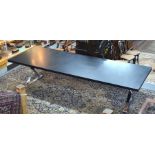 A large contemporary Italian design dining table, the rectangular black ash top raised on chrome cro