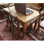 A small French oak dining table with rectangular top  on a shaped fries and turned supports